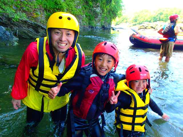 Kids have a big smile in the river.